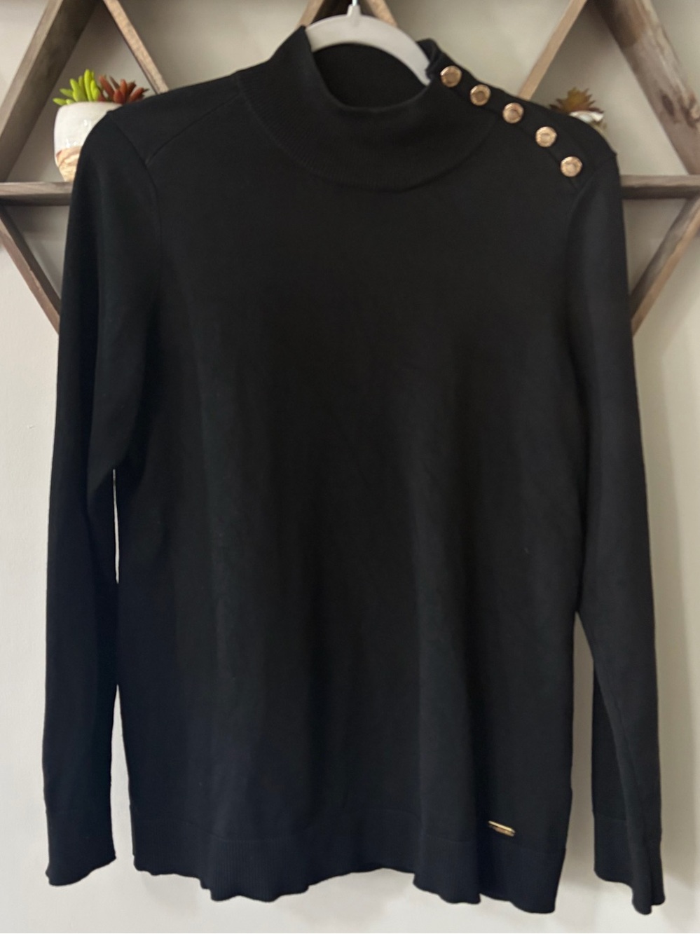 Calvin Klein Black Mock
Neck Sweater Gold
Button Shoulder Women’s size medium.